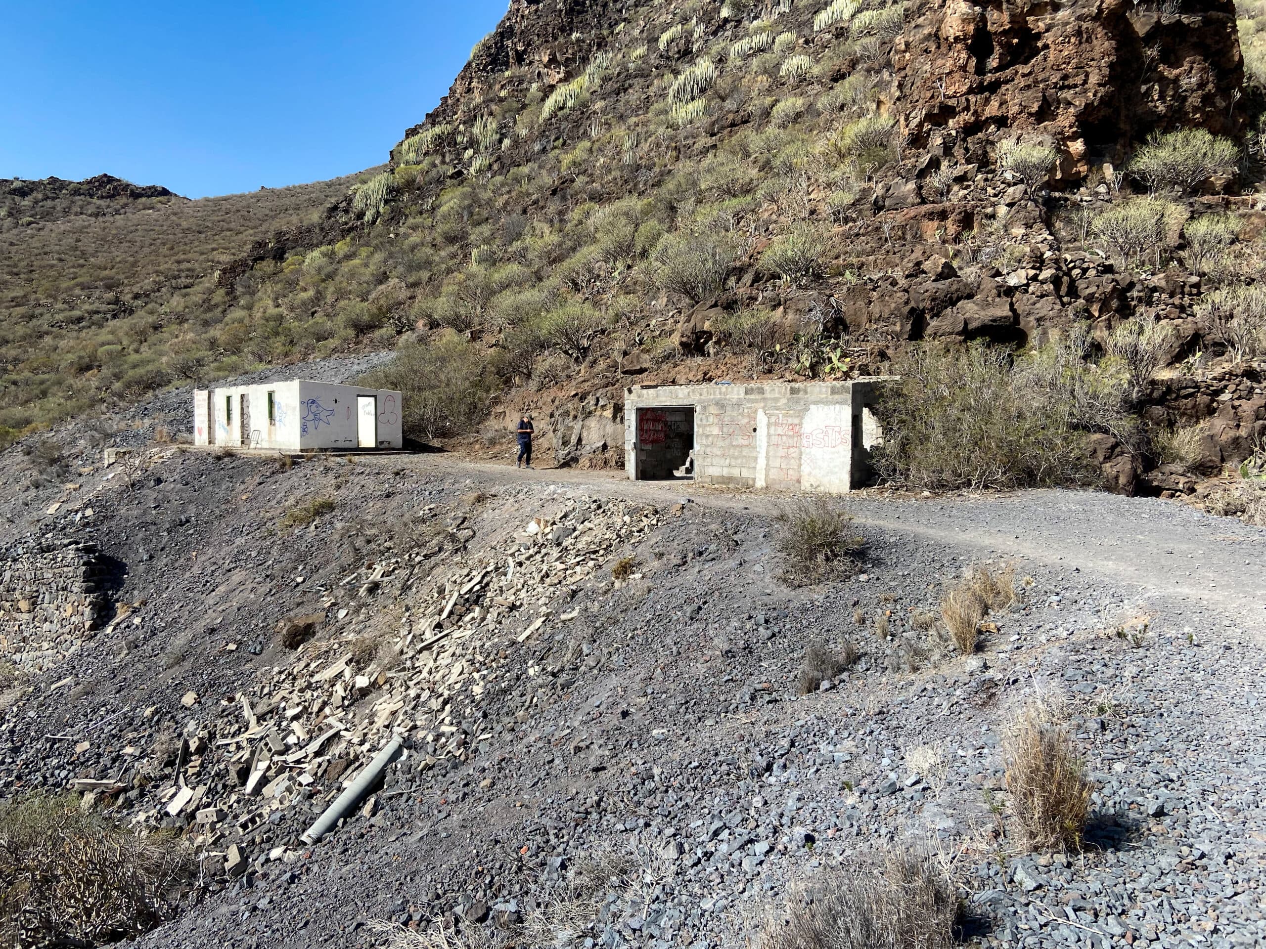 Tunnel entrance and a man who lets hikers into the tunnel with the key