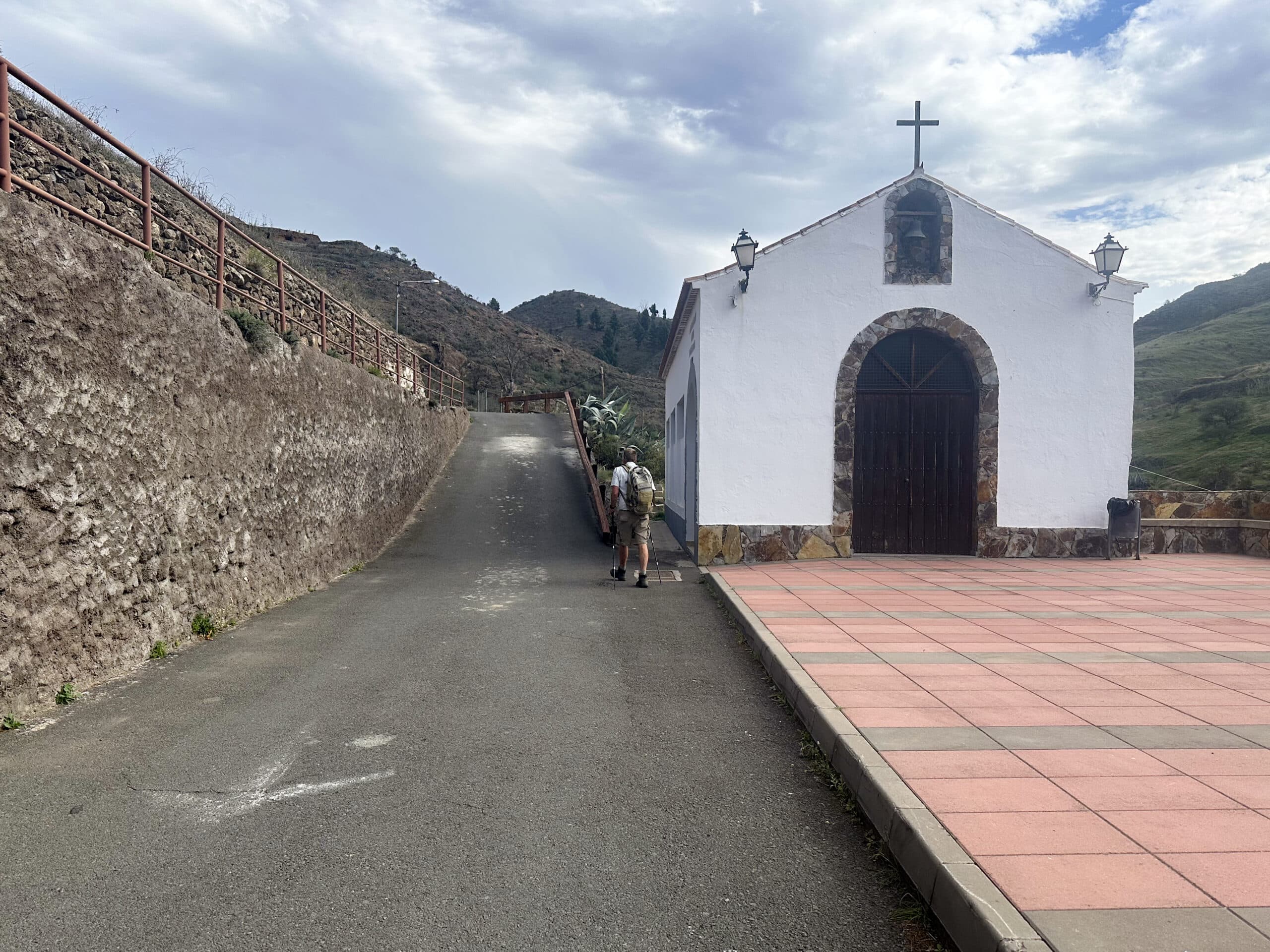 Hiker on the hiking trail in front of the Ermita de San Antonio