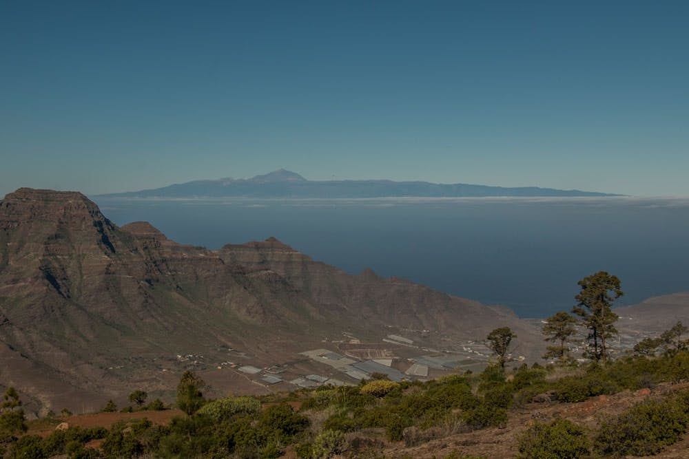 view from the hight to the valley of Aldea - in the background Tenerife and Teide
