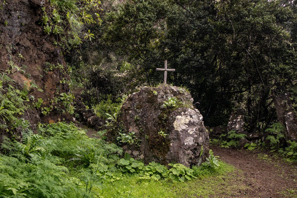 Stone with cross at the hiking path