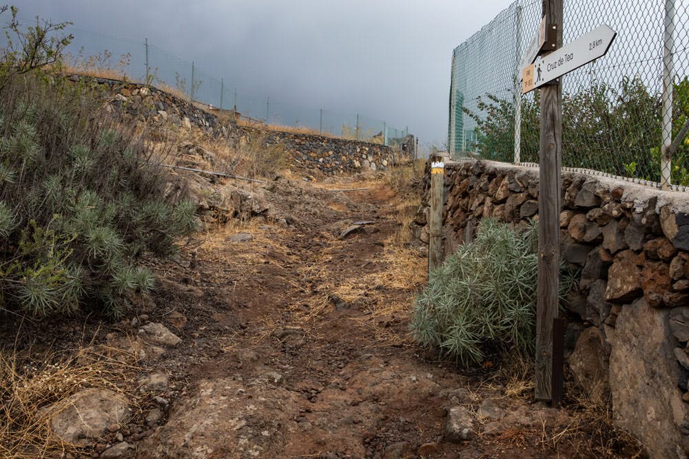 hiking path with signpost - Montaña de las Coloradas