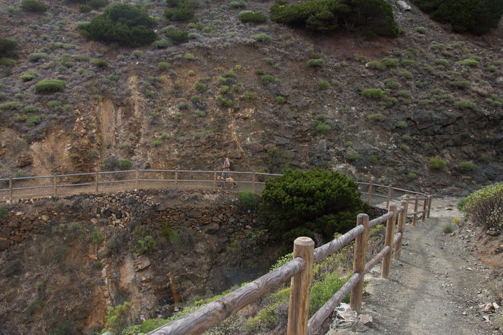 Hiking path from the steep cliffs down to the road in the gorge of Tamargada