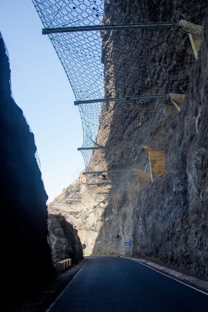 The steel net above the street protects against falling rocks and stones