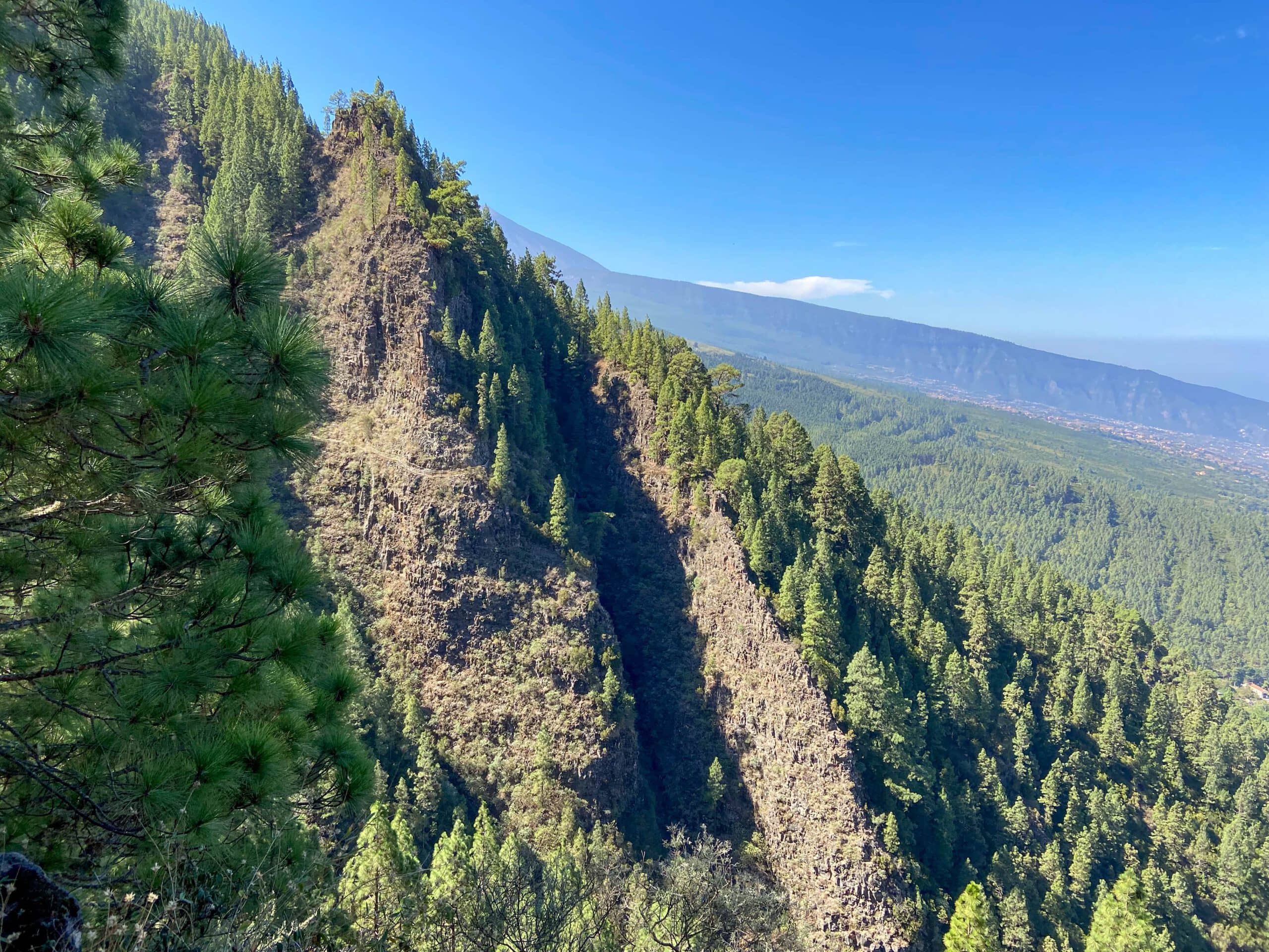 The high-altitude trail runs along rugged rock faces