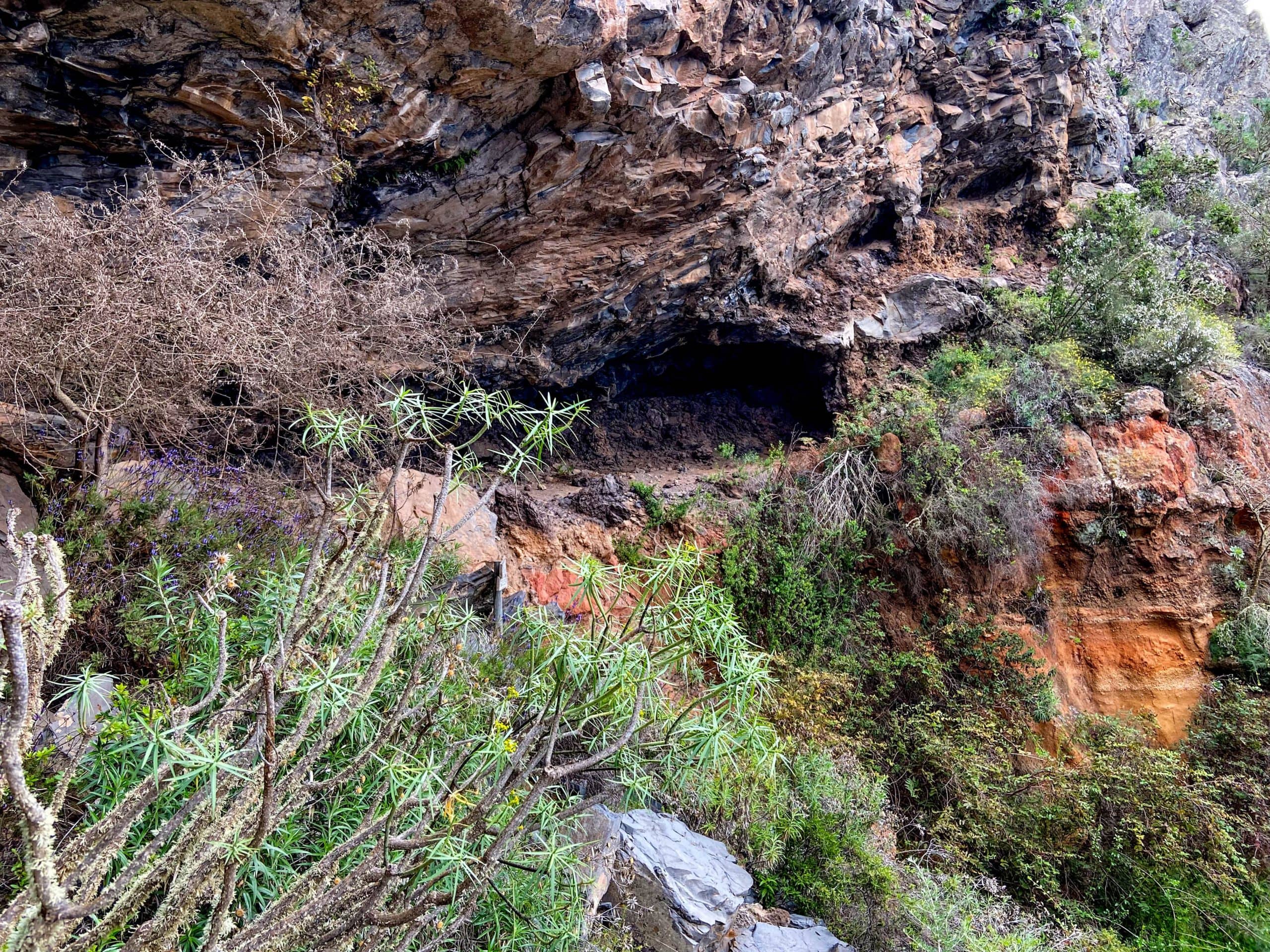 Hidden cave in the rock wall