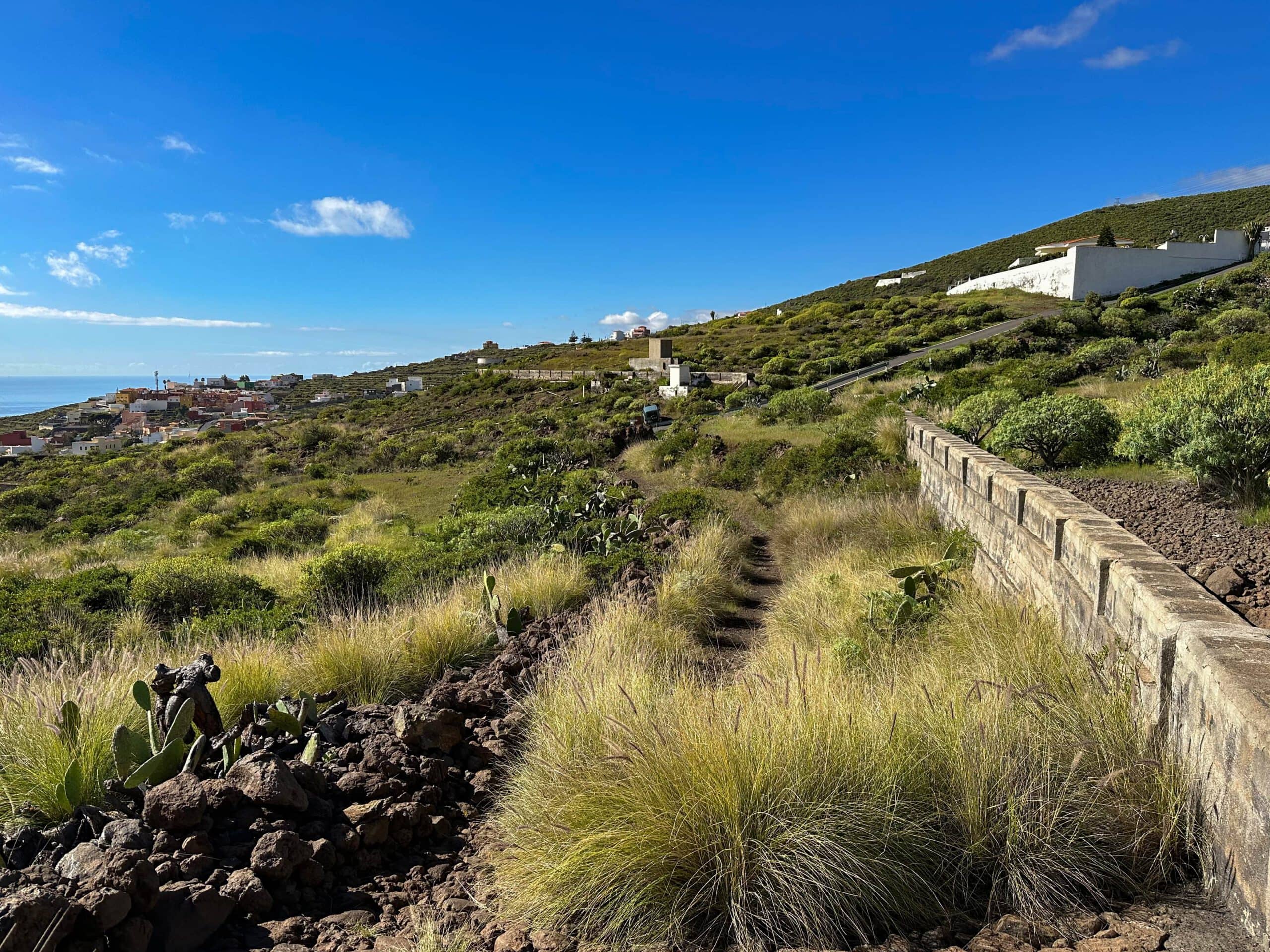 Hiking trail with a view back to the village of Barranco Hondo along the canal