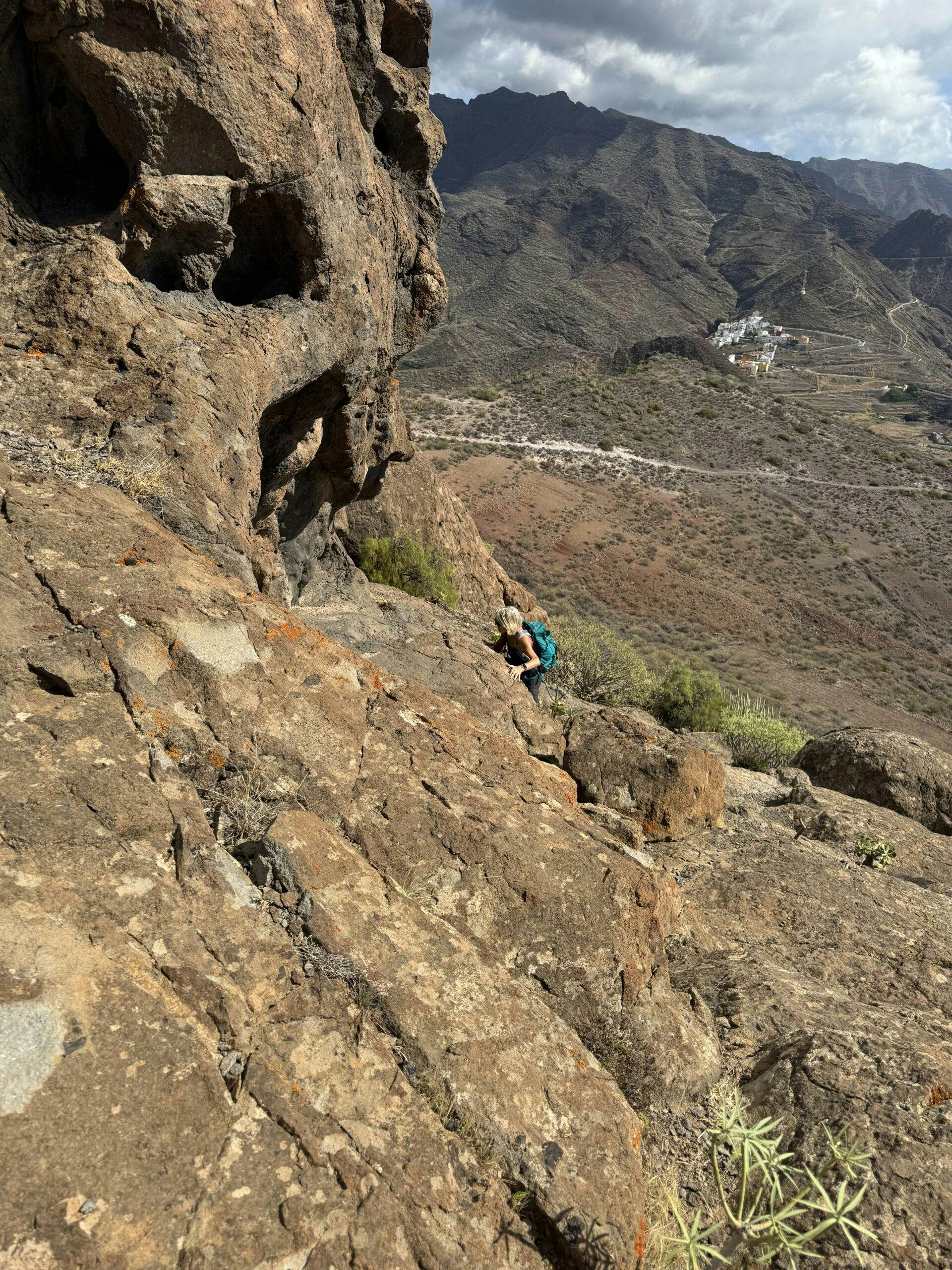 Blick vom Felsentor hinunter - Wanderin auf dem Weg bergauf
