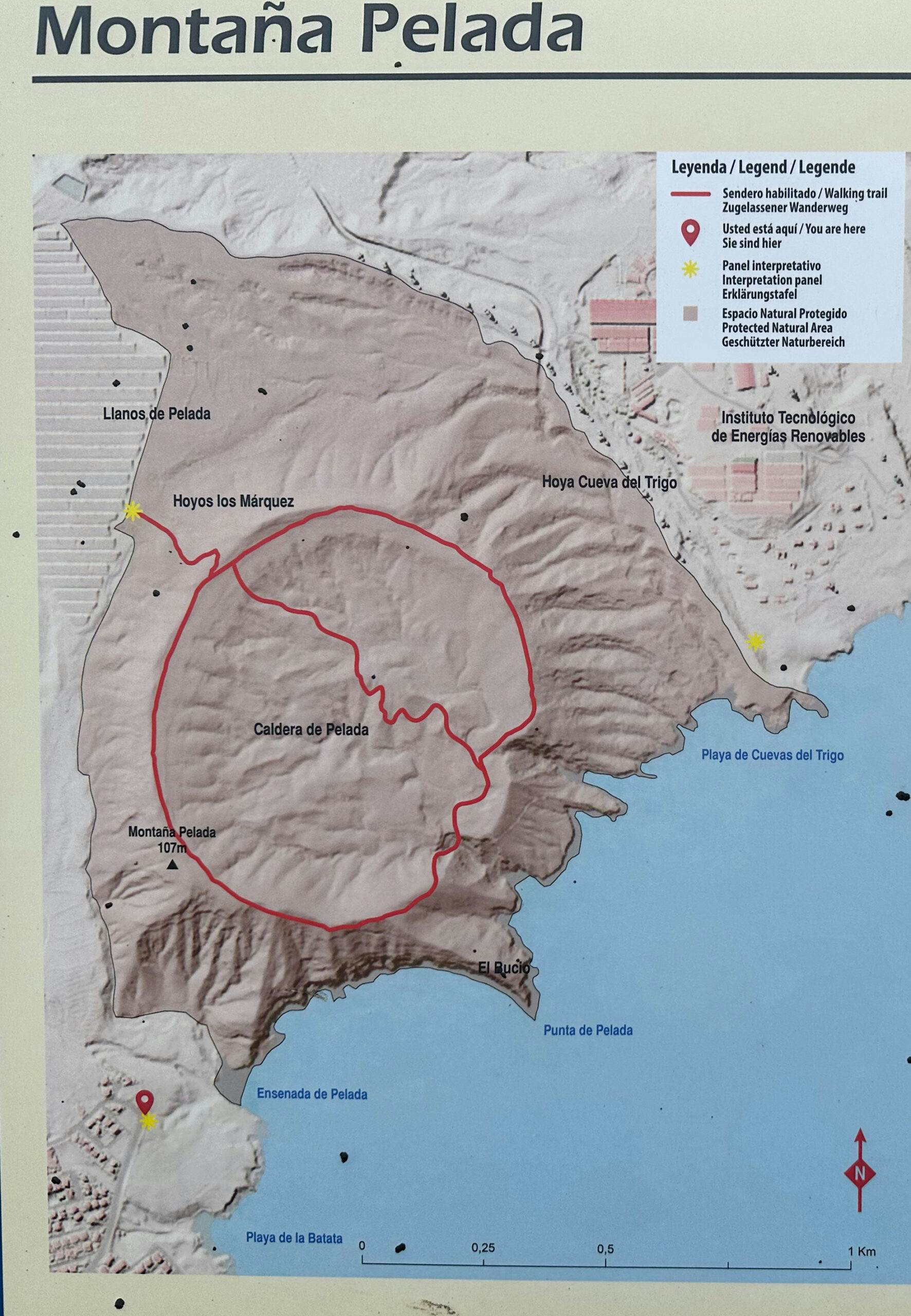 Information board for the Montaña Pelada hiking trail with hiking trail and crossing of the crater