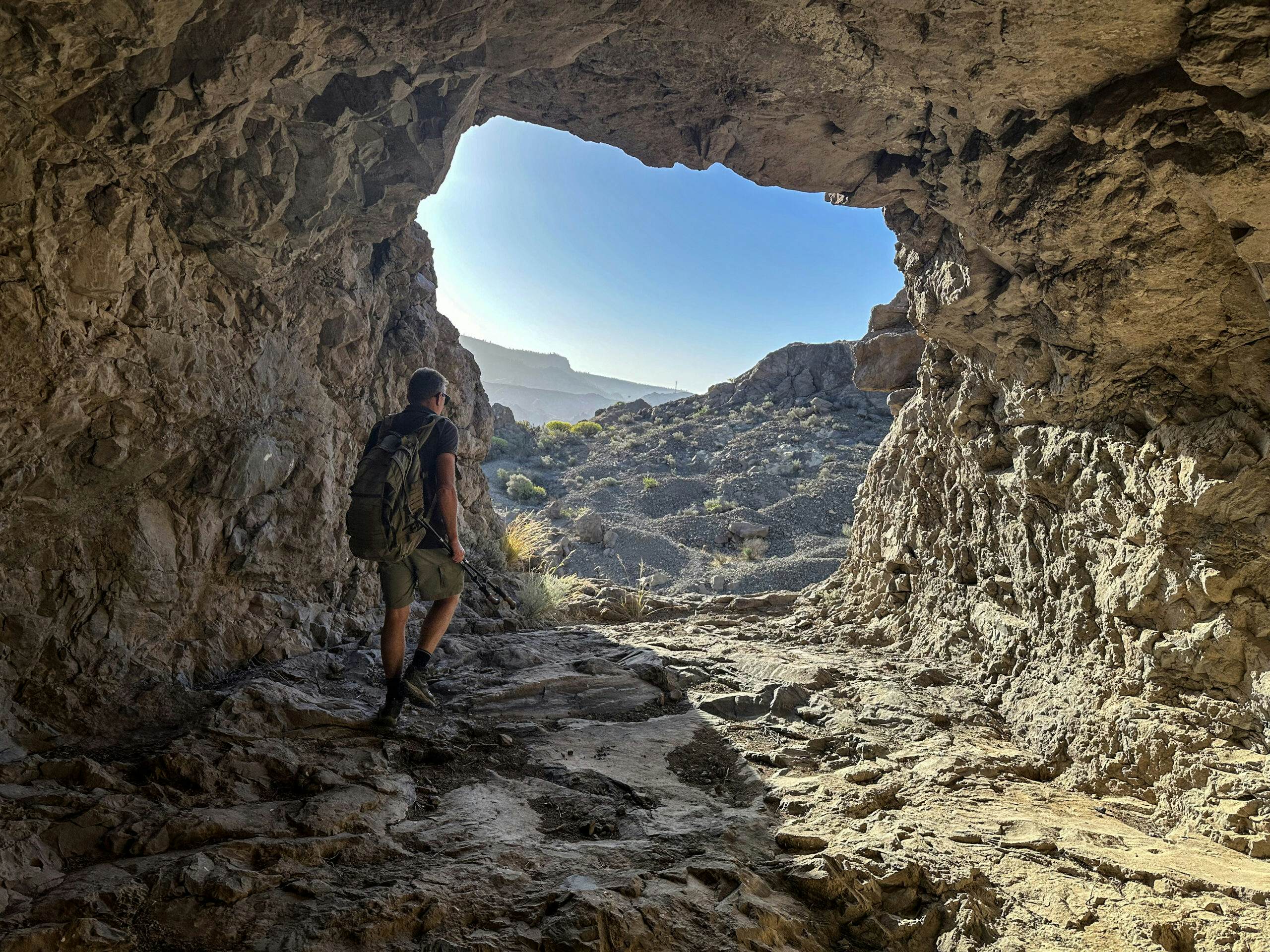 Hiker at the tunnel exit near the Presa de Las Niñas dam