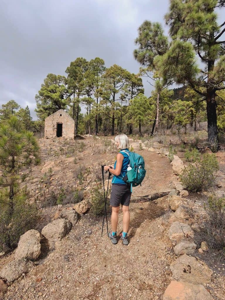 after the first steep ascent in front of a ruined house